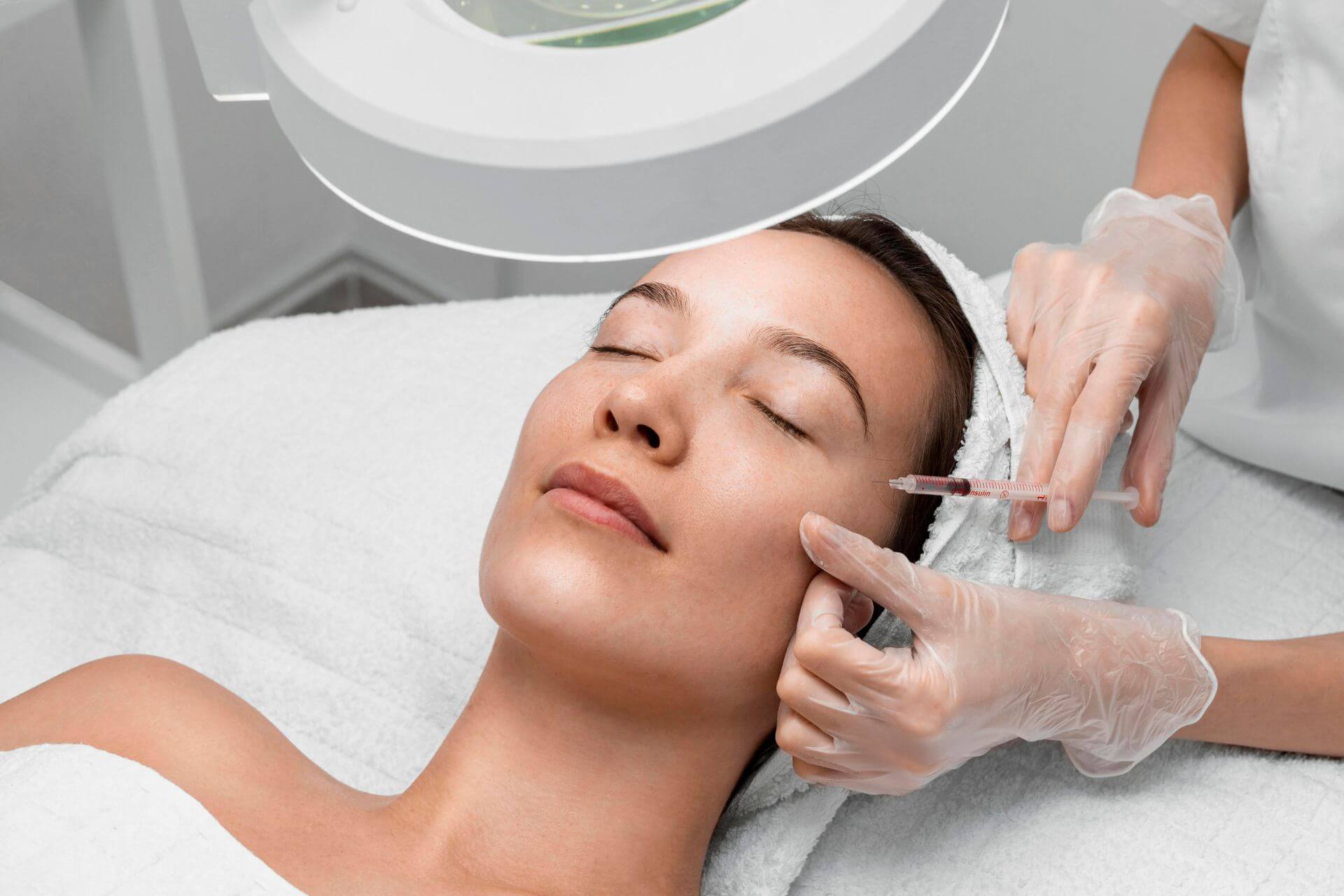 Woman having skin booster injection treatment